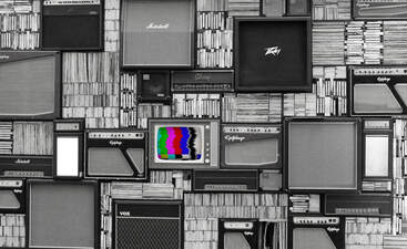 various black and white televisions and stereos with one television having blurred, colored lines in center